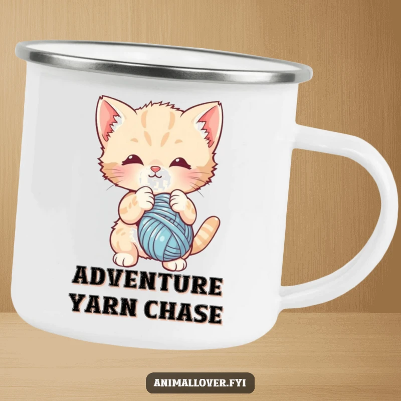 Funny camping mug with a cute kitten batting at a ball of yarn. Designed for cheerful outdoor enjoyment.