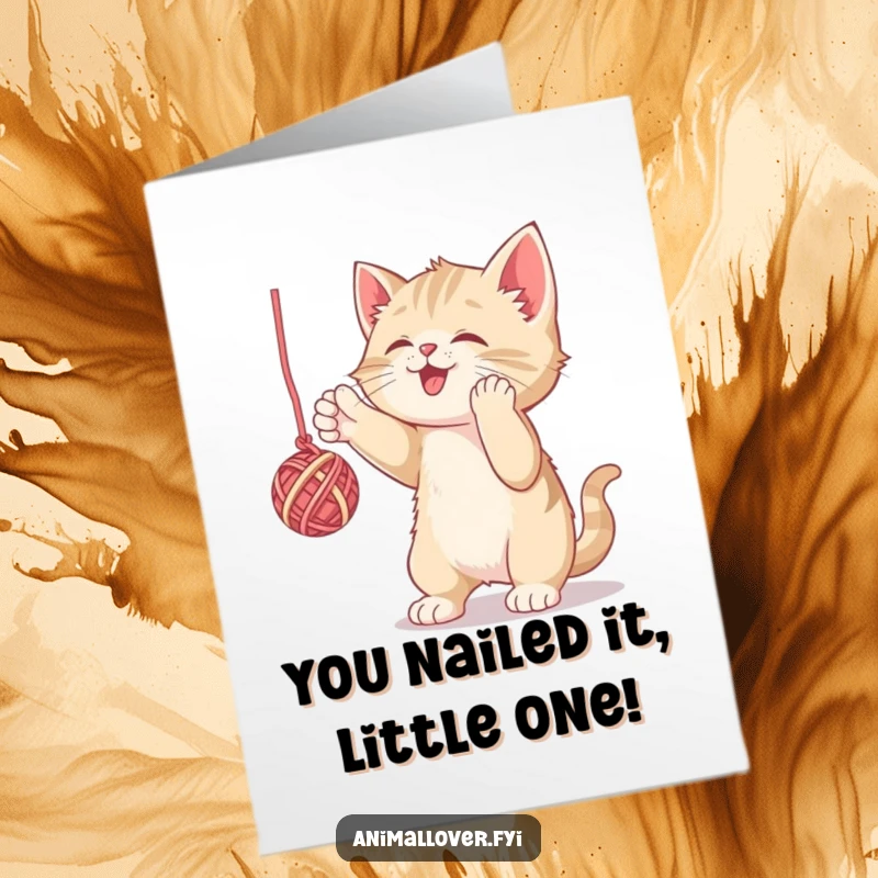 Funny Free Printable Congratulations Card: A victorious kitten triumphantly batting a ball of yarn, celebrating achievements, downloadable art.